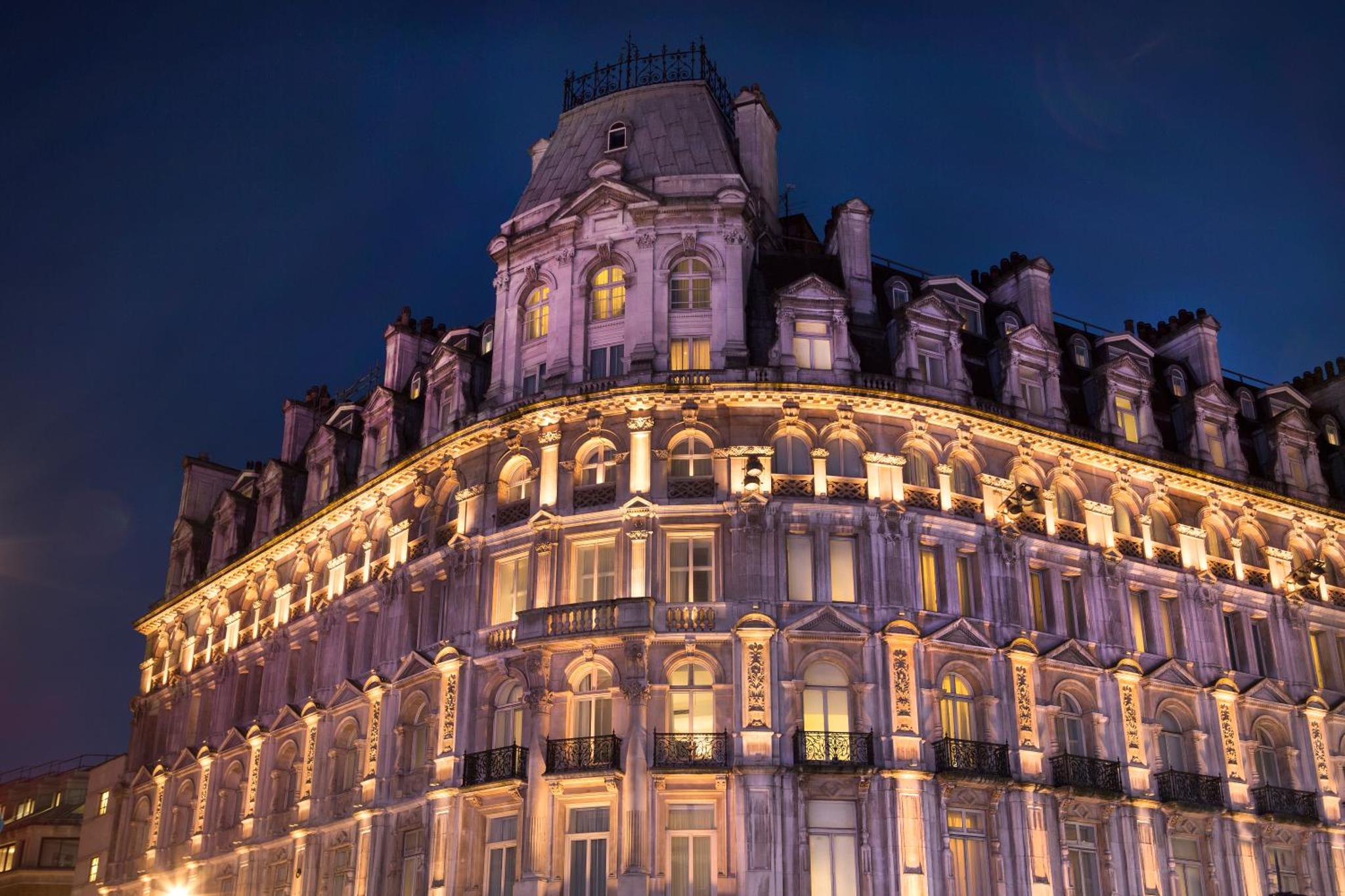 a lit up building at night at Thistle London Piccadilly in London
