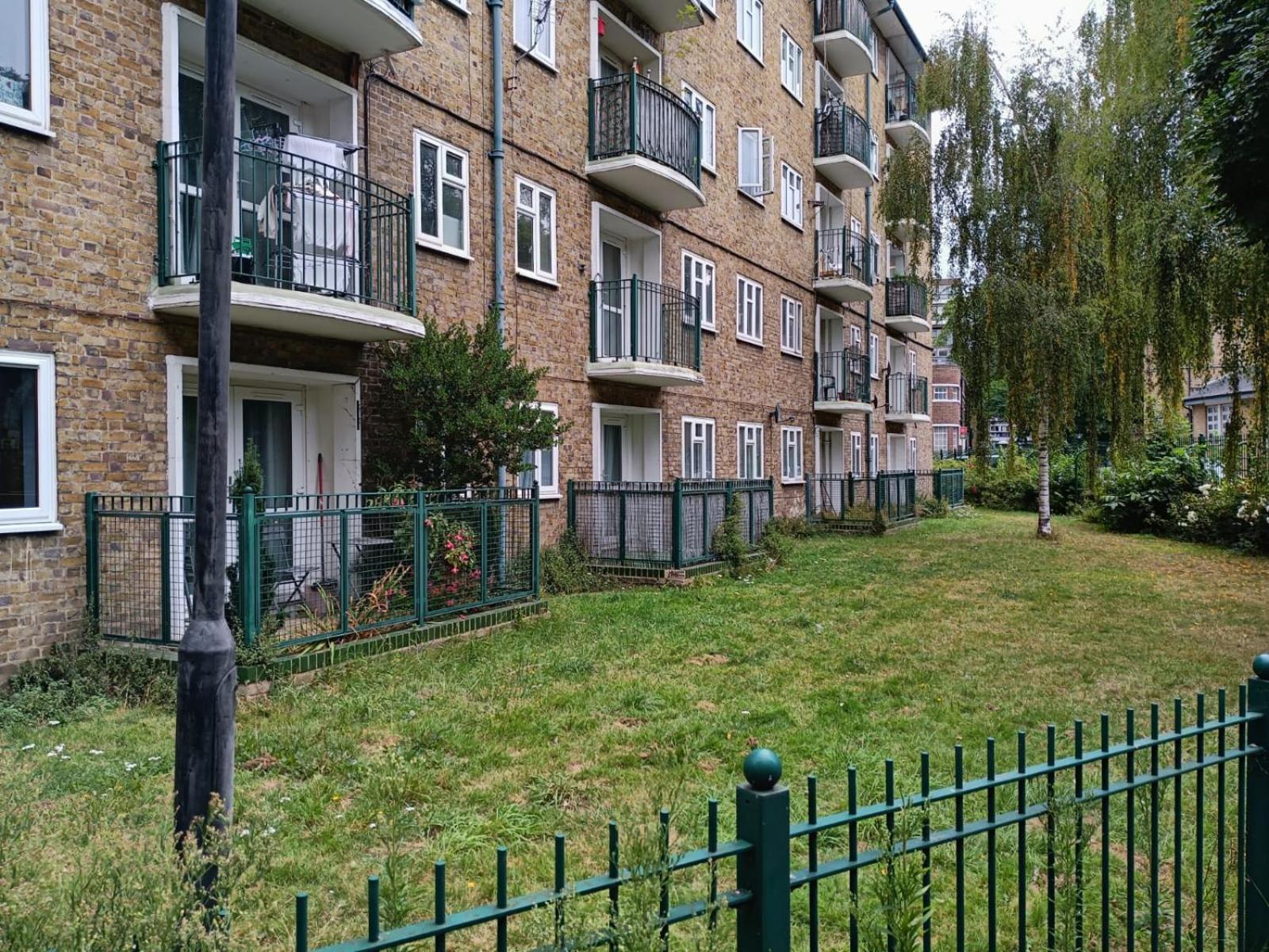a fence in front of an apartment building at The London Apartment in London