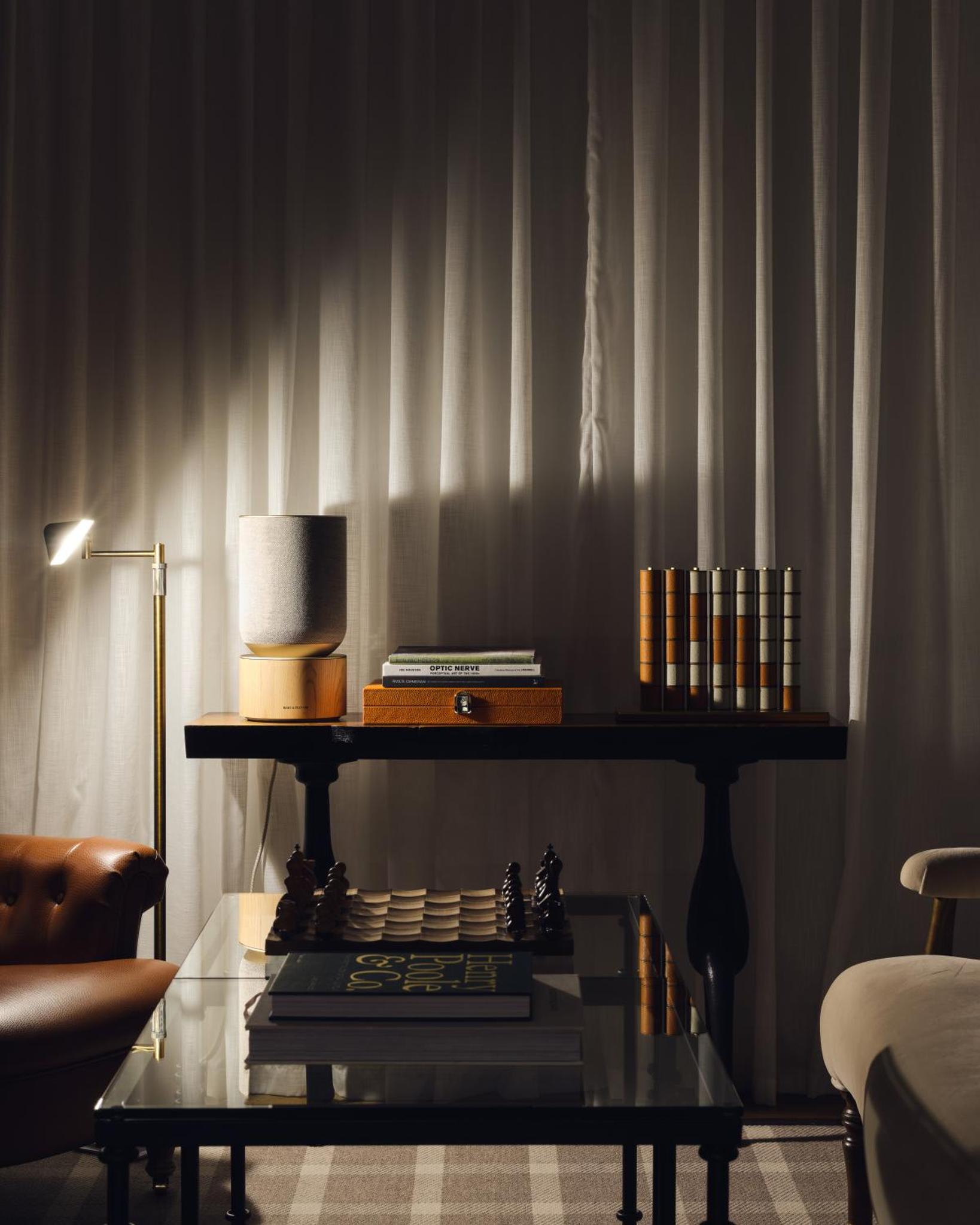 a living room with a glass table and a shelf at The Adria in London