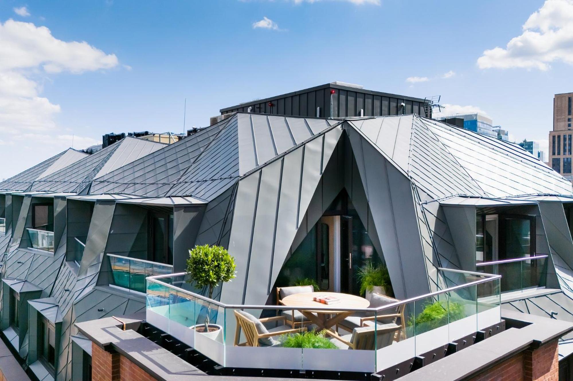 a house with a metal roof on top of a building at Wilde Aparthotels London Liverpool Street in London