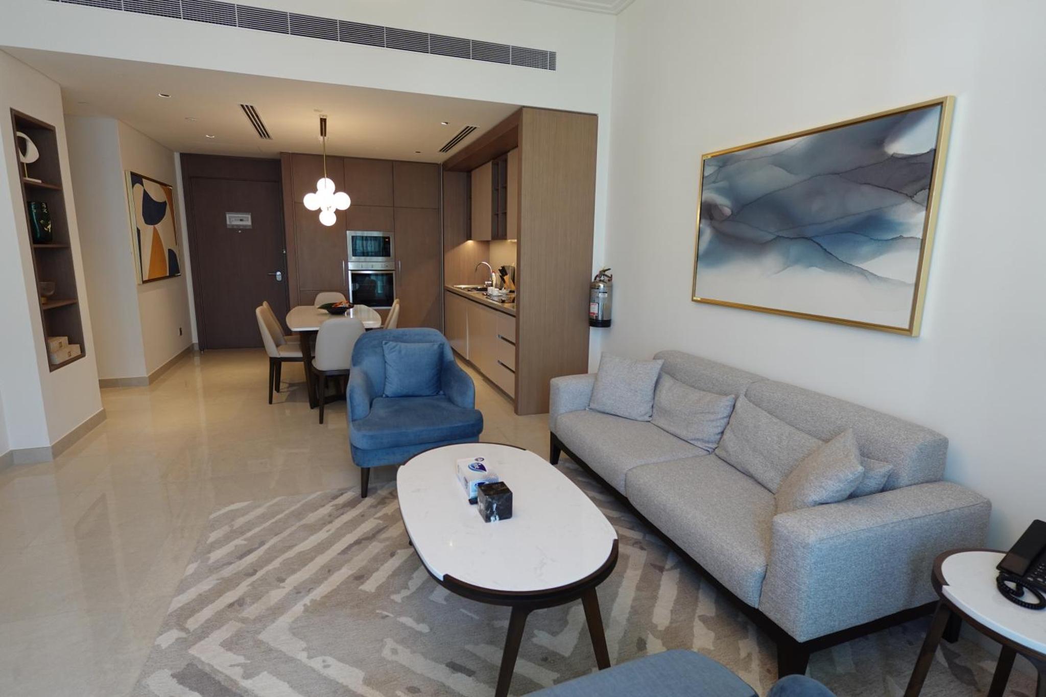 a living room with a couch and a table at Address Residence Bahrain in Rayyā +45 photos