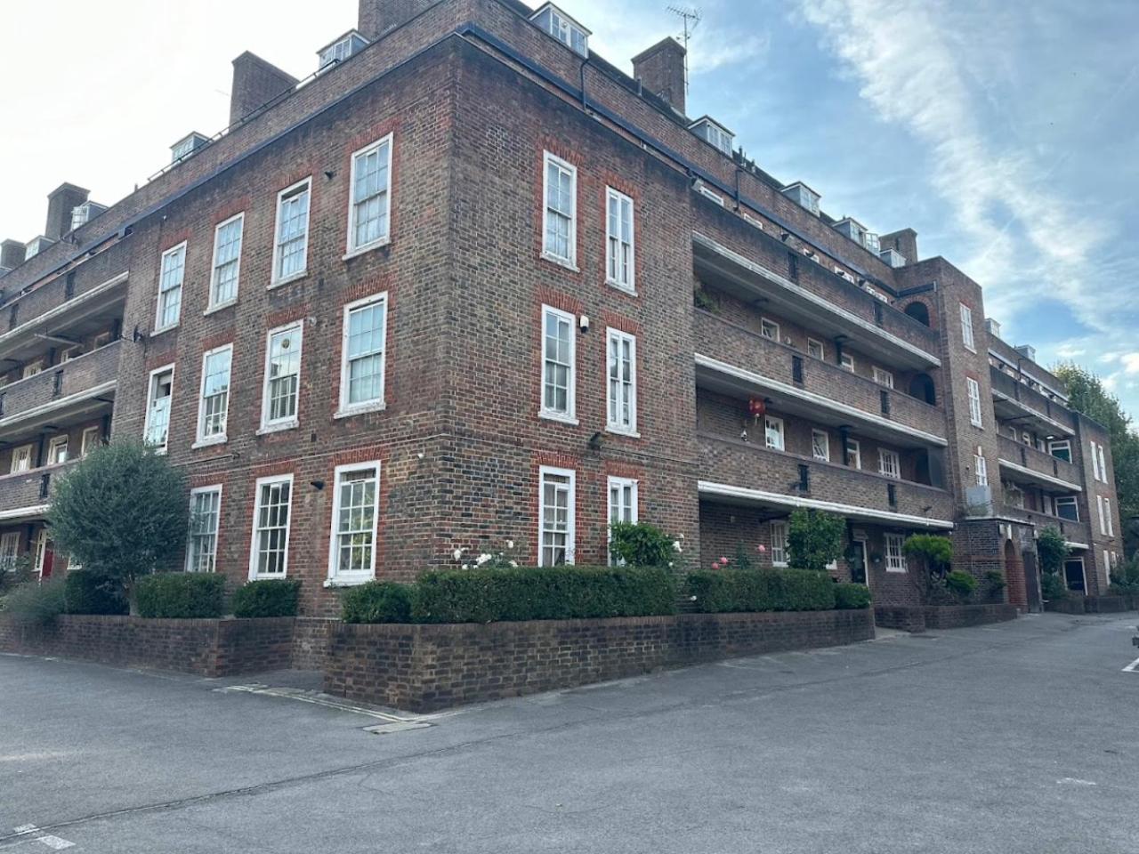 a large brick building with white windows on a street at Quiet location in central London, close to Paddington, Regent Park, Lord's Cricket, late check-in in London
