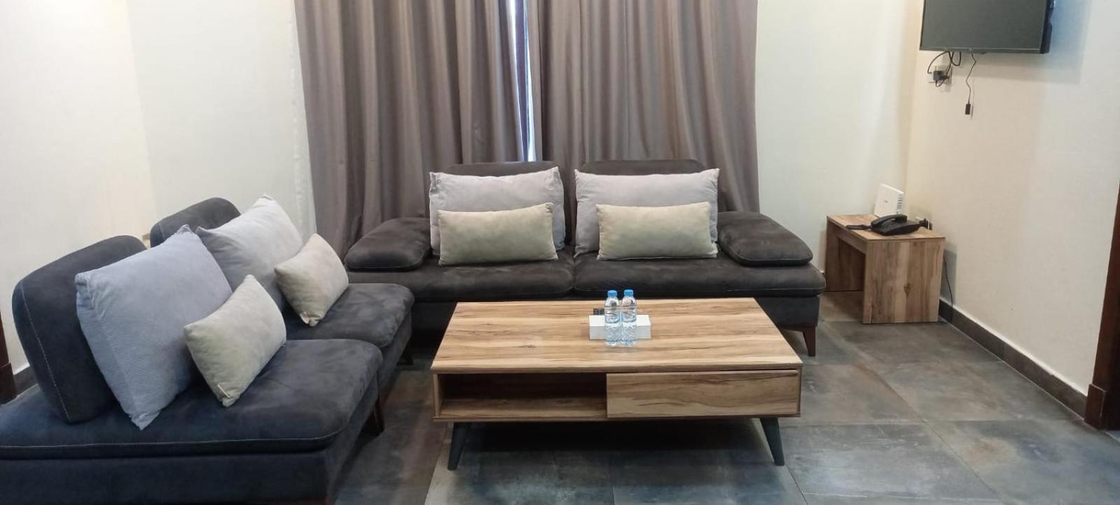 a living room with two couches and a coffee table at Tanger Tower in Manama