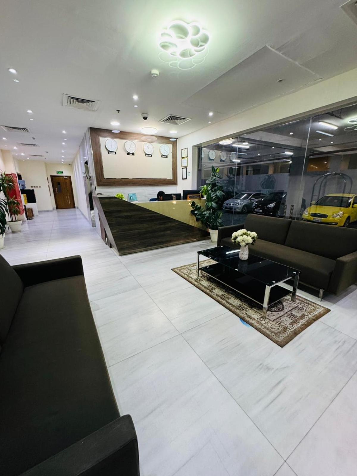 a lobby with couches and a yellow car in a dealership at Tanger Tower in Manama