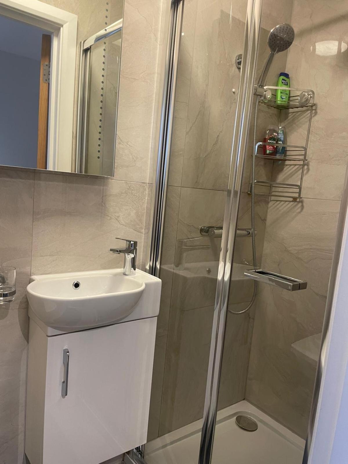 a bathroom with a shower and a sink at Grays Inn Road - Room 1 in London