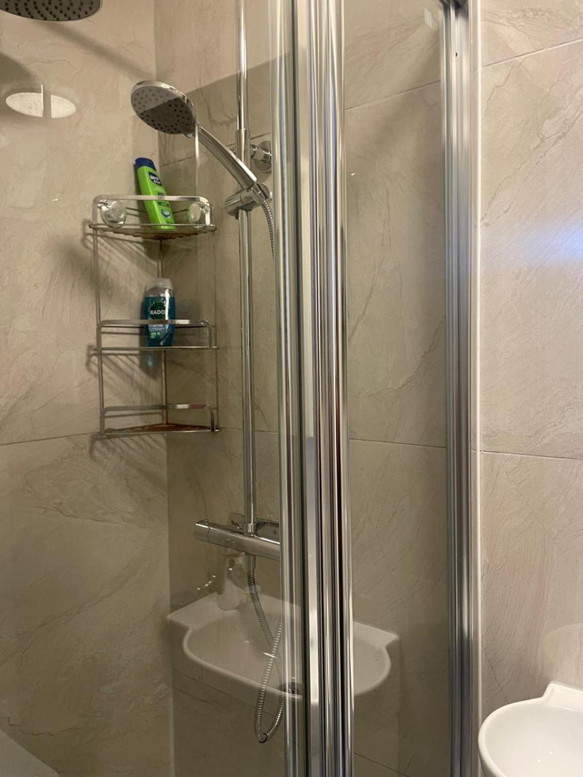 a shower with a glass door in a bathroom at Grays Inn Road - Room 1 in London