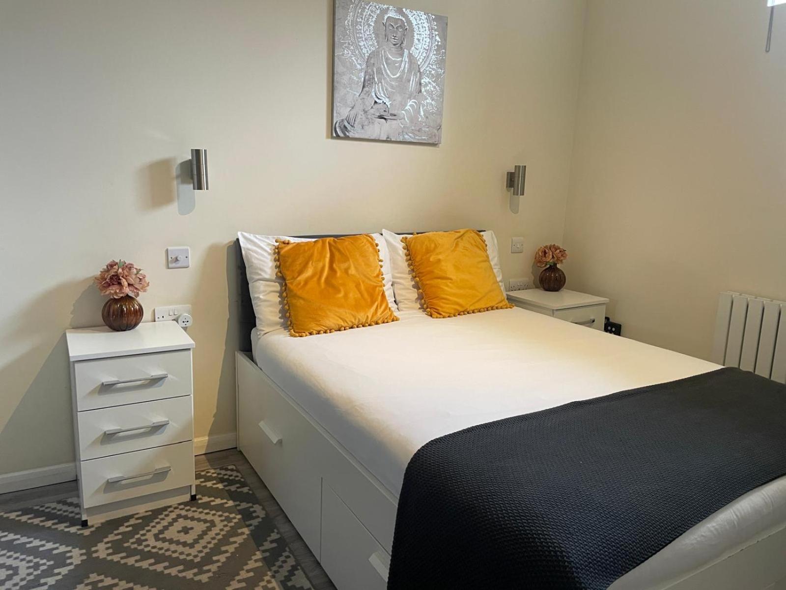 a bedroom with a large bed with yellow pillows at Grays Inn Road - Room 1 in London