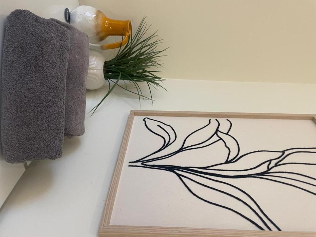 a drawing of a plant on a table next to a towel at Grays Inn Road - Room 1 in London