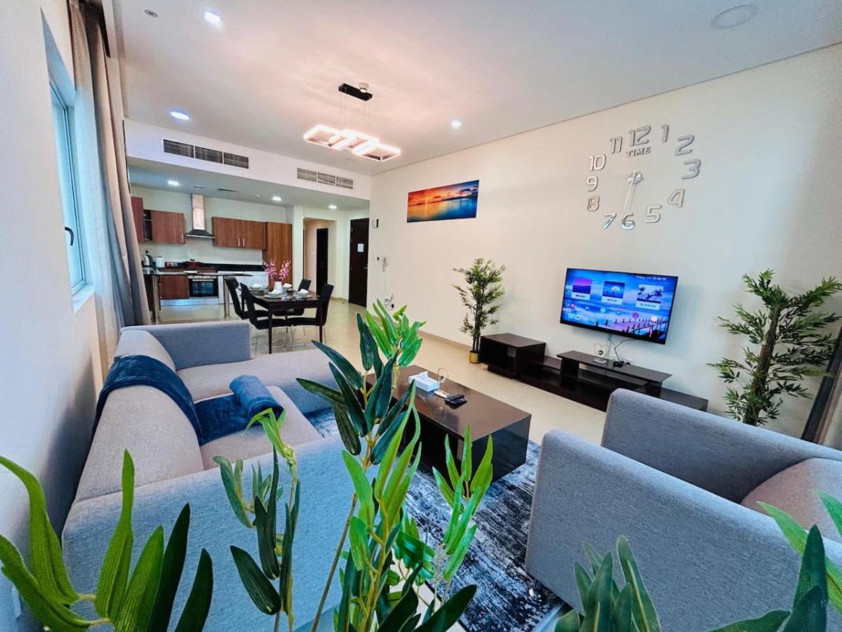 a living room with couches and a tv at Aspire Tower -Vibrant Two Bedroom in Juffair in Manama
