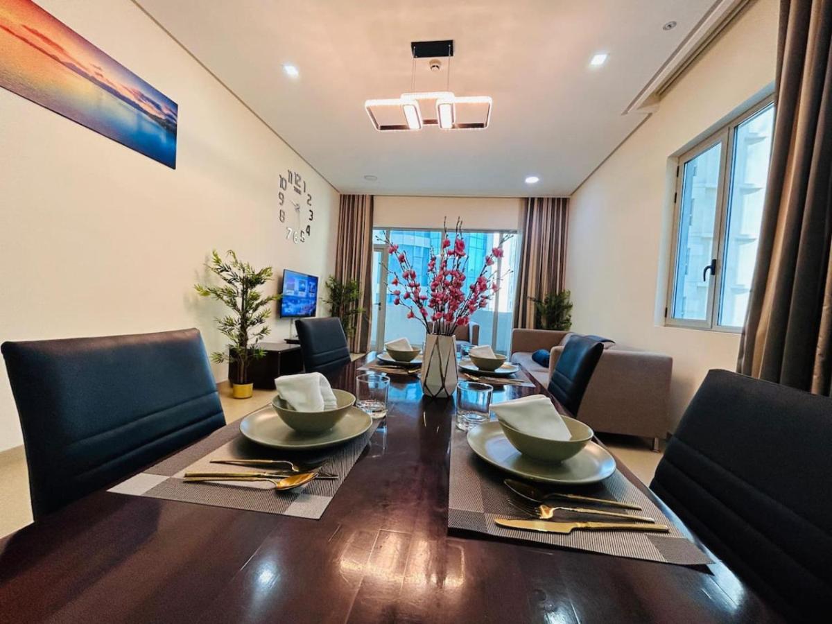 a dining room with a table and chairs at Aspire Tower -Vibrant Two Bedroom in Juffair in Manama