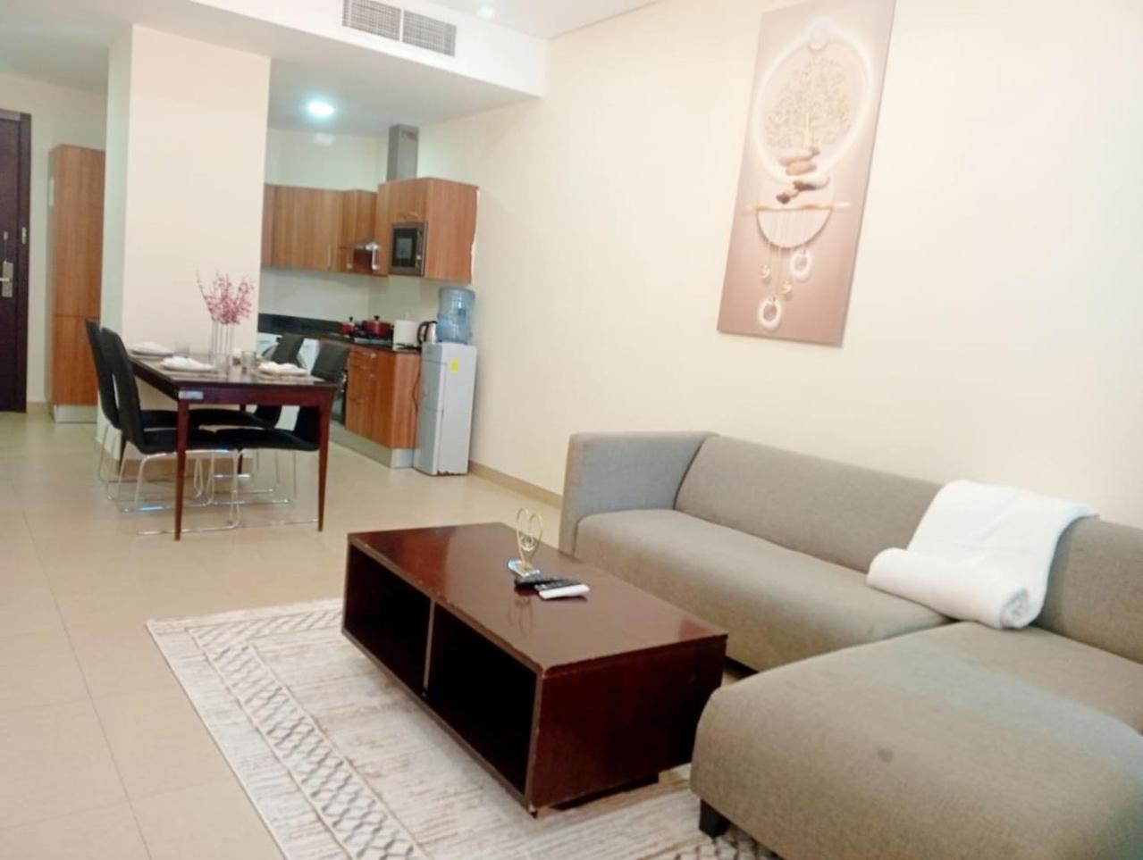 a living room with a couch and a table at Aspire Tower-VIP Modern Luxury Pad in Manama