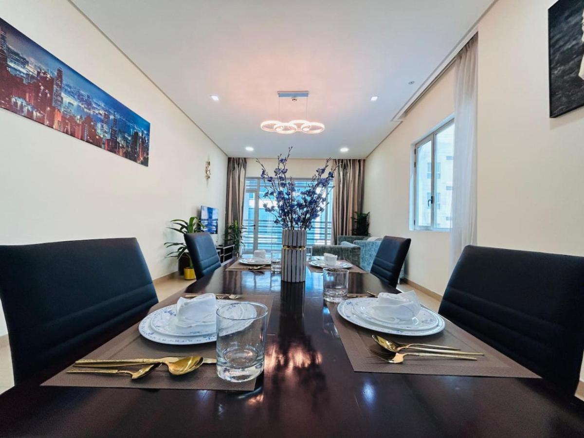 a dining room with a table with chairs and a dining room at Aspire Tower-Two Bedroom Retreat Juffair in Manama