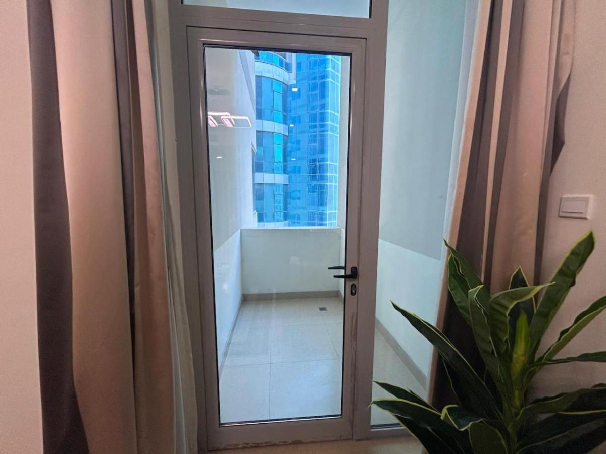a door leading into a room with a window at Aspire Tower-One Bedroom Blissful Nest in Manama