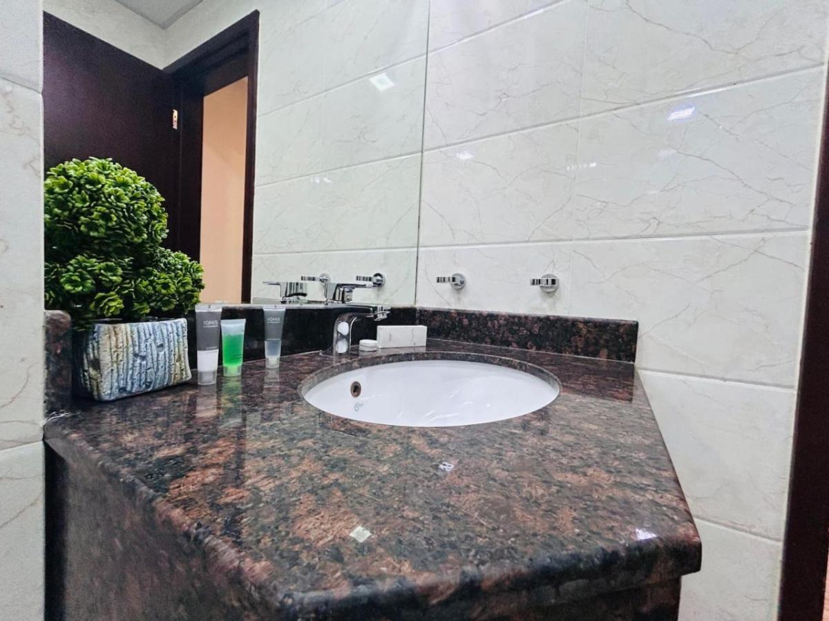 a bathroom sink with a marble counter top at Aspire Tower -One Bedroom Quaint Nest Juffair in Manama