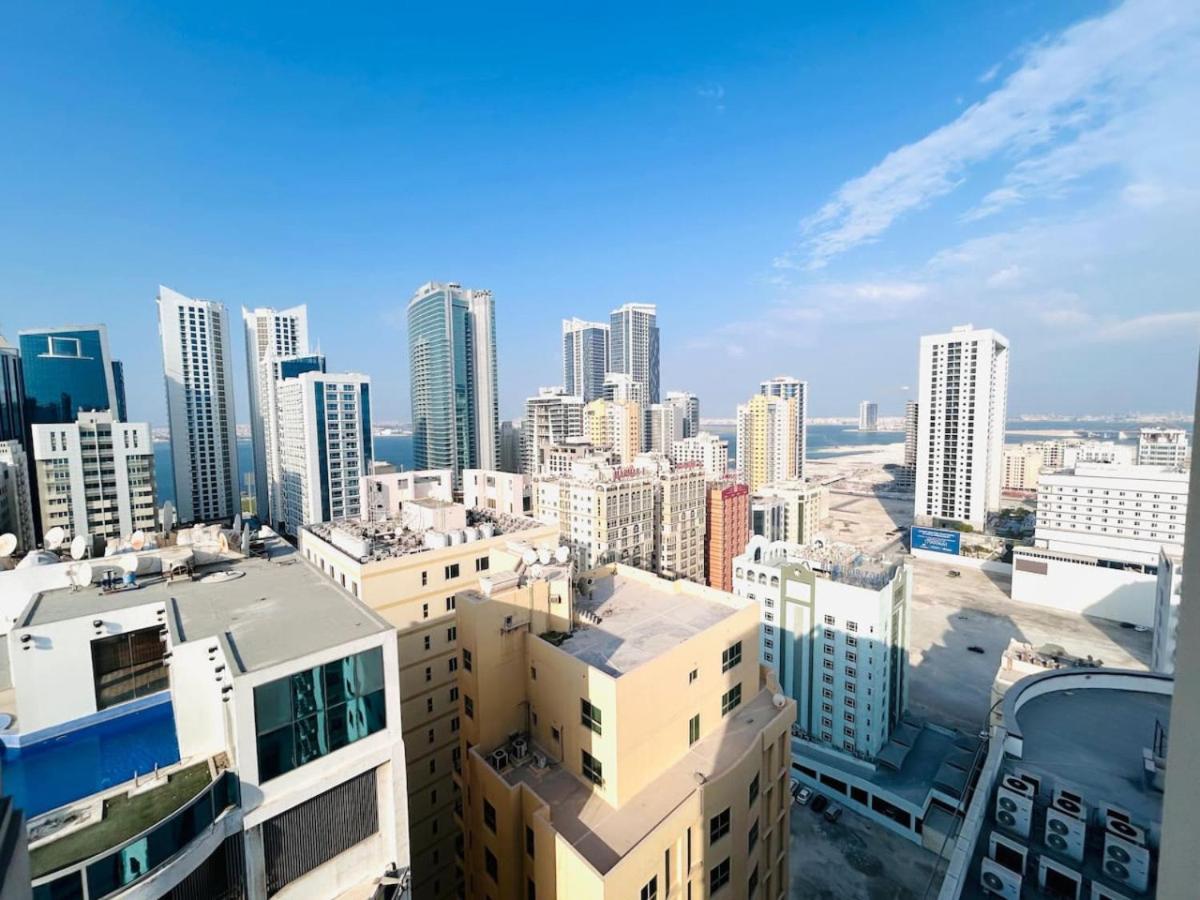 a view of a city skyline with tall buildings at Aspire Tower -One Bedroom Quaint Nest Juffair in Manama