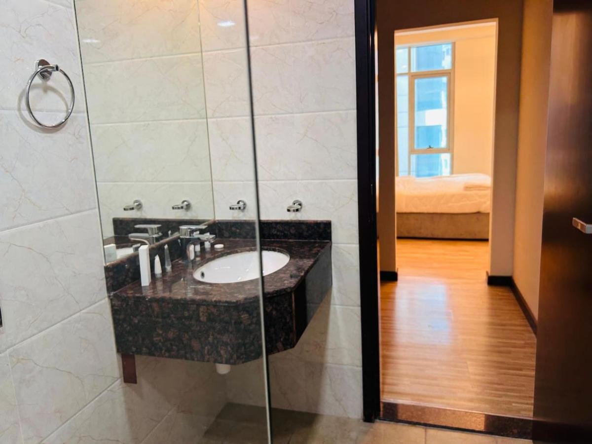 a bathroom with a sink and a shower at Aspire Tower-One Bedroom Sunny Solo Stay in Manama