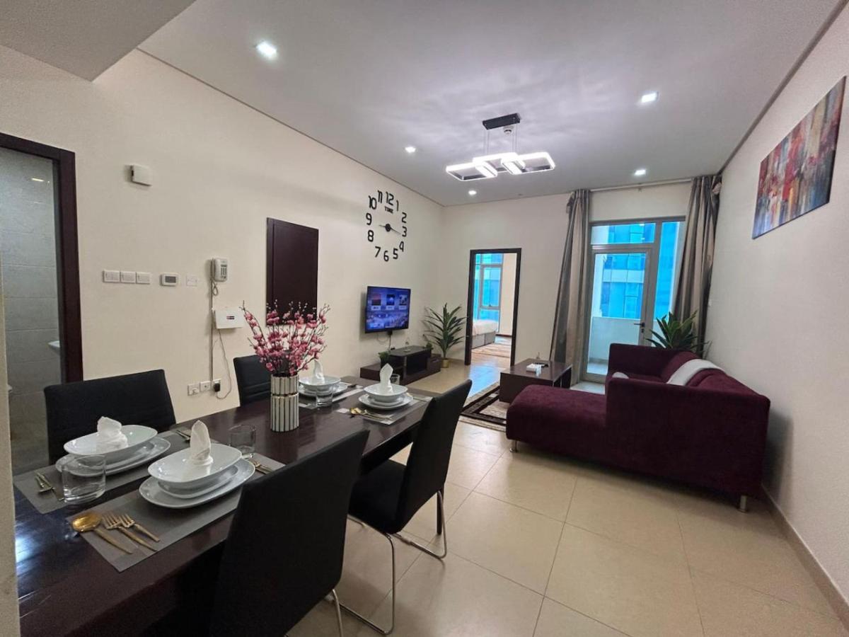 a living room with a dining room table and a couch at Aspire Tower-One Bedroom Blissful Nest in Manama