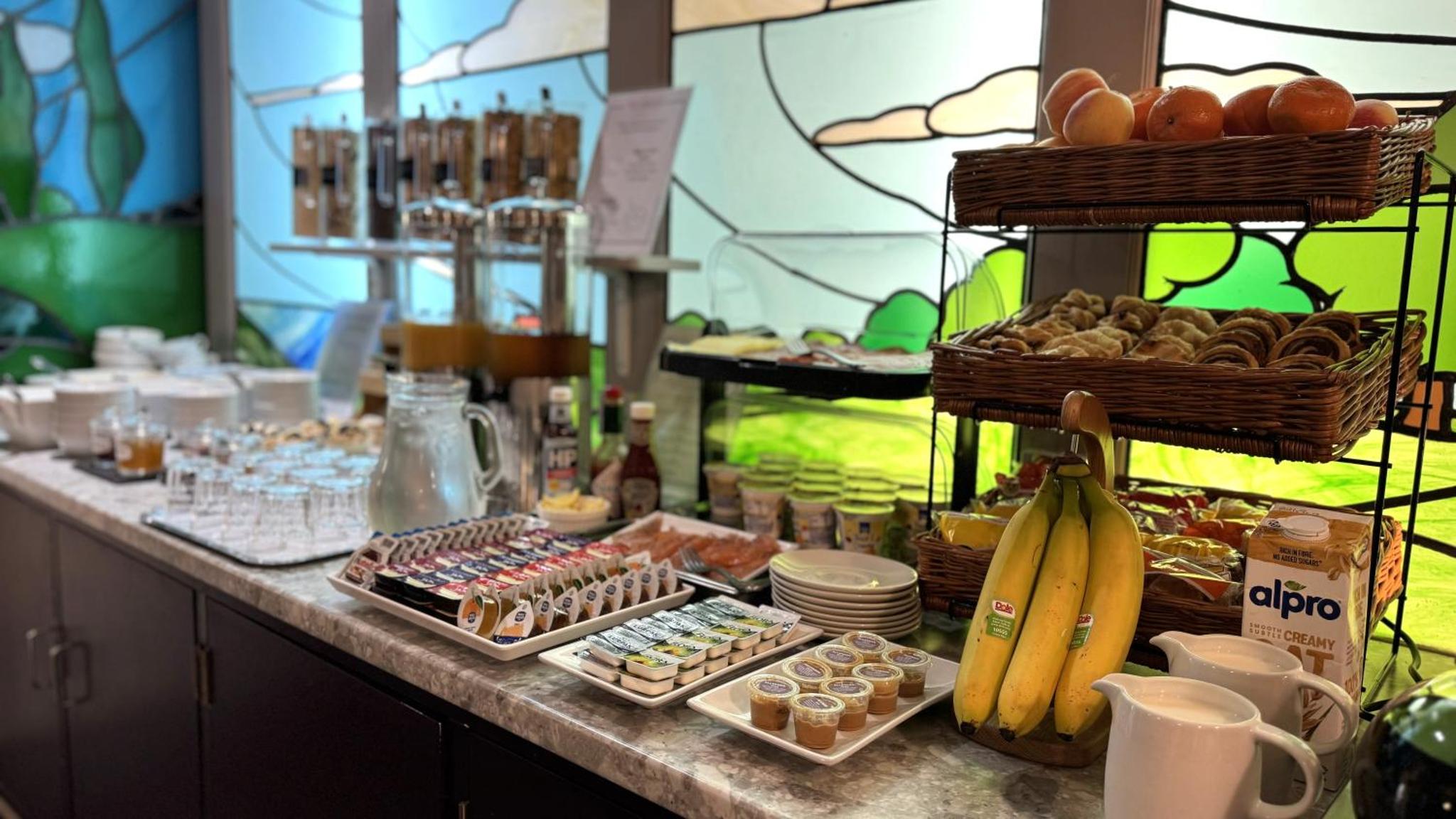 a buffet with pastries and other food on a counter at Harlingford Hotel in London +53 photos