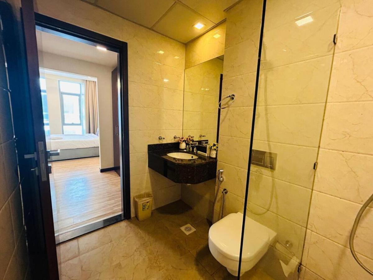 a bathroom with a toilet and a sink at Aspire Tower -Skyline Retreat Juffair in Manama
