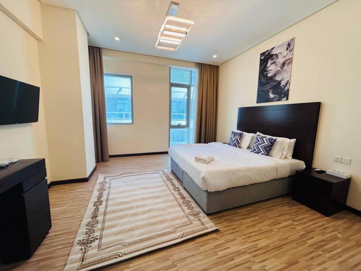 a bedroom with a large bed in a room at Aspire Tower -Skyline Retreat Juffair in Manama
