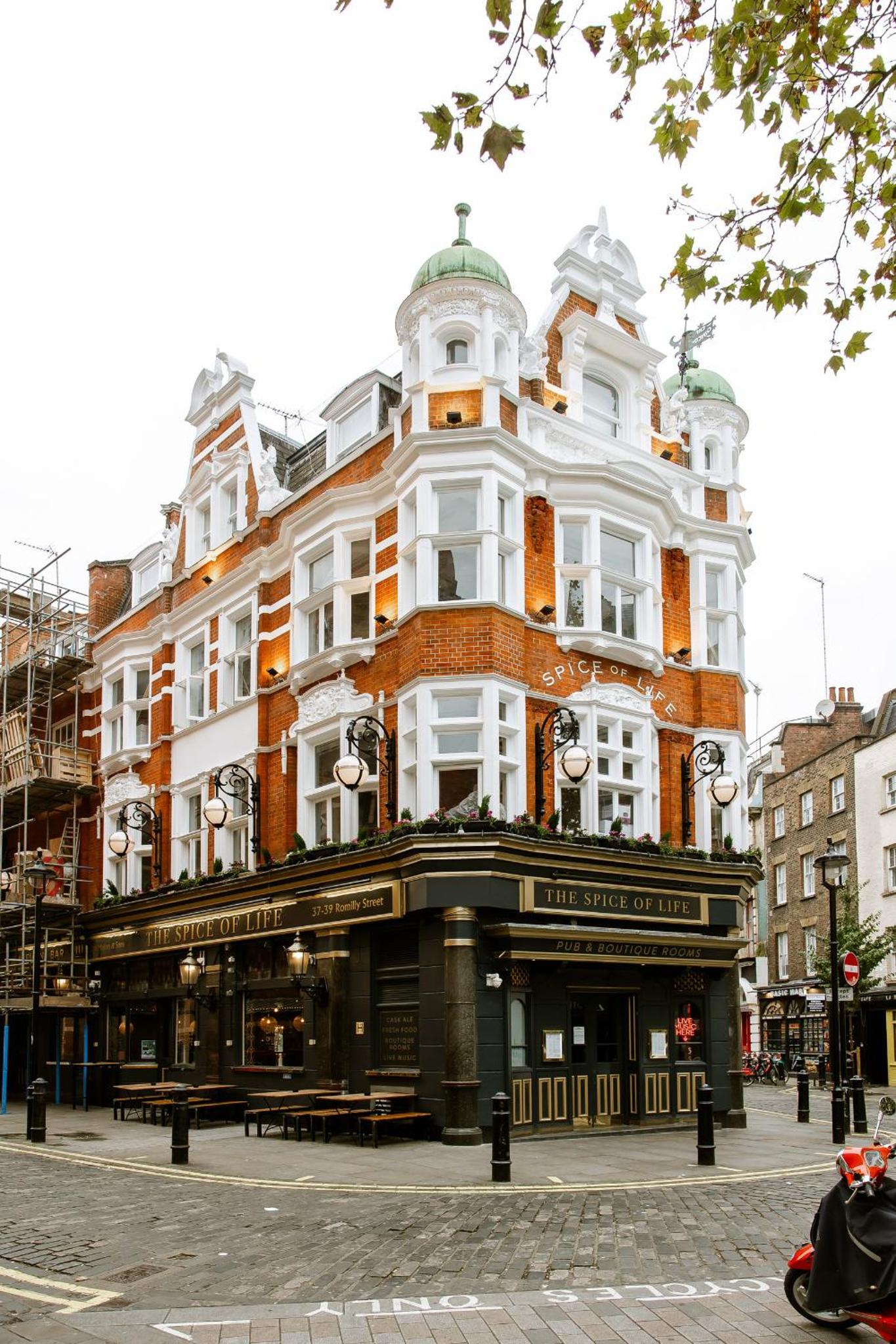 a large white building on the corner of a street at The Spice of Life in London