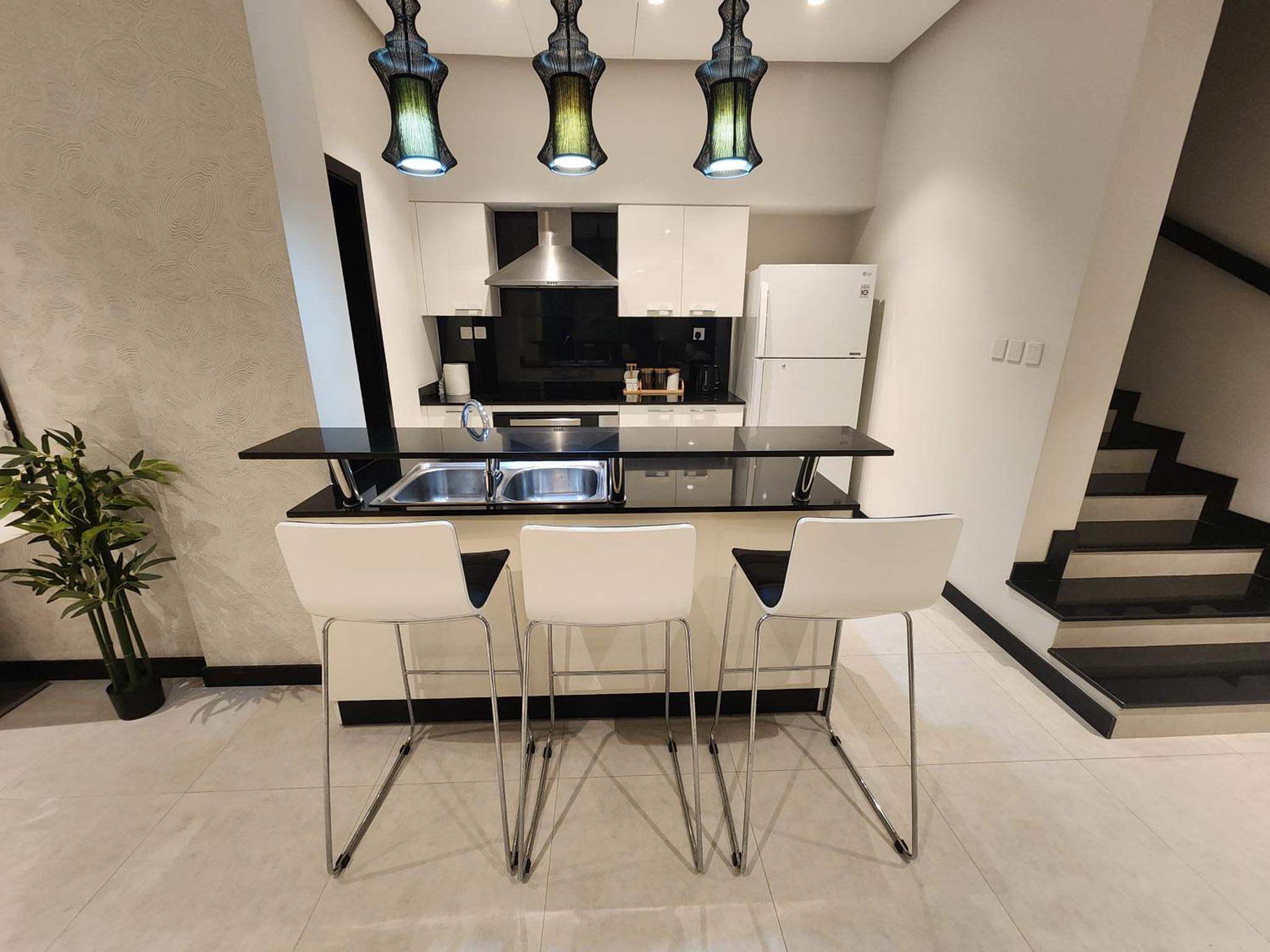 a kitchen with a counter and some white appliances at Stunning Sea View 3BR Duplex in Reef Island in Sanābis