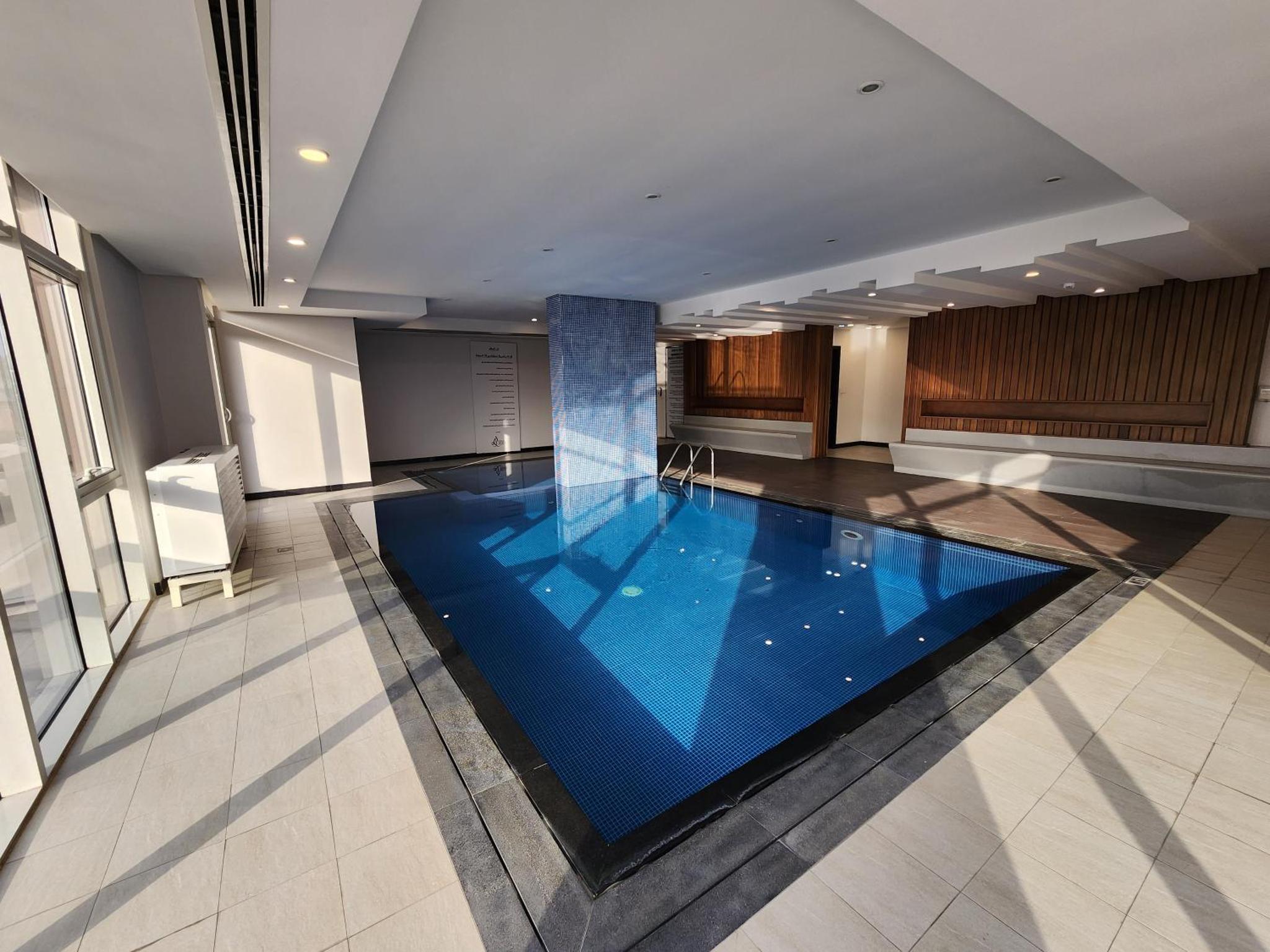a swimming pool in the middle of a building at Stunning Sea View 3BR Duplex in Reef Island in Sanābis