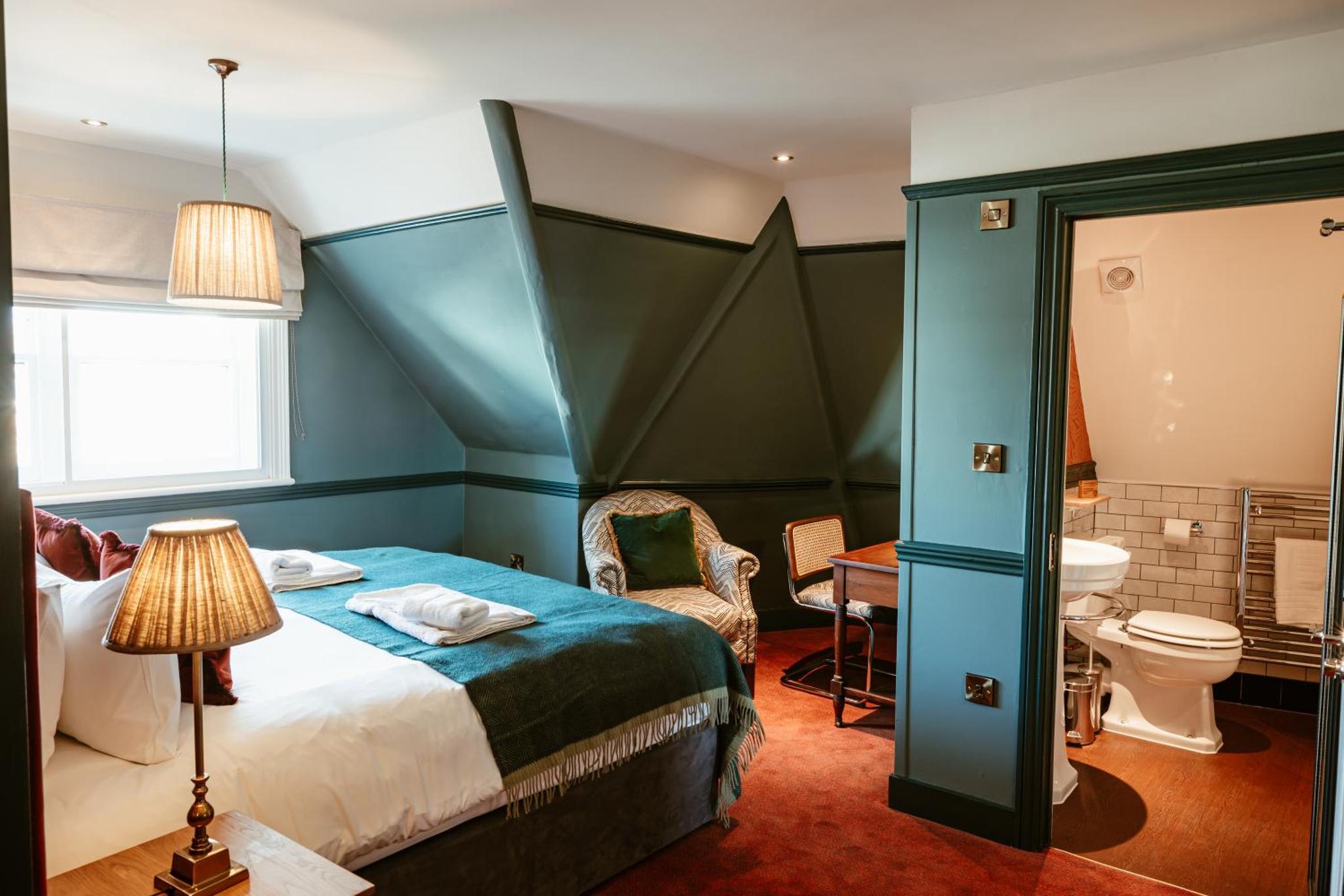 a bedroom with a bed and a toilet and a sink at Hand & Flower in London +287 photos