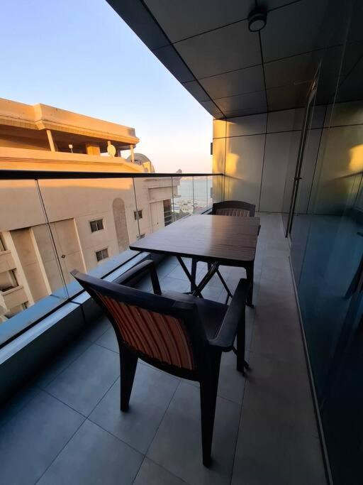 a table and chairs on the balcony of a building at Home on Holiday -Apartments in Manama
