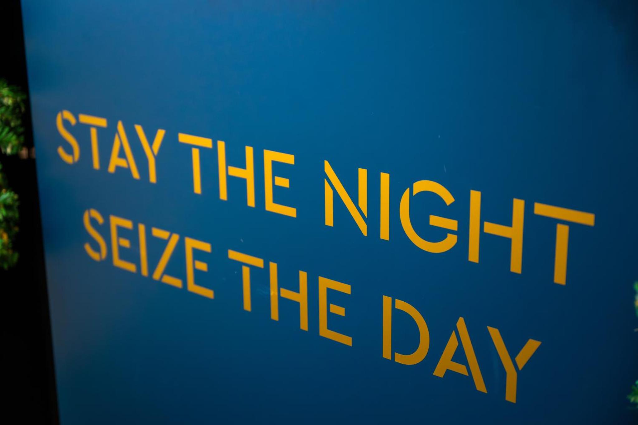 a sign that says stay the night seize the day at NOX Belsize Park in London