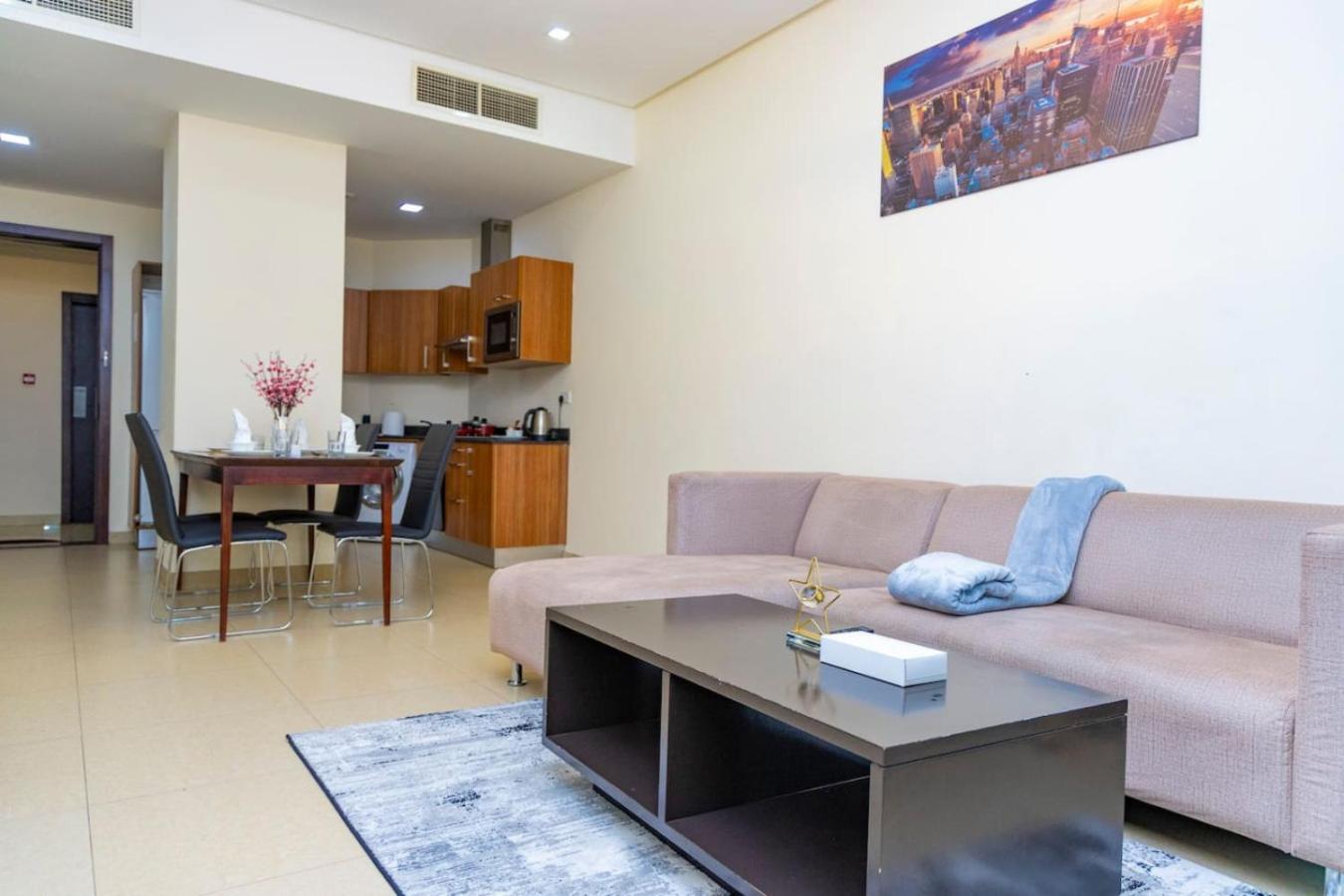 a living room with a couch and a table at Aspire Tower - Unique One Bedroom in Juffair in Manama