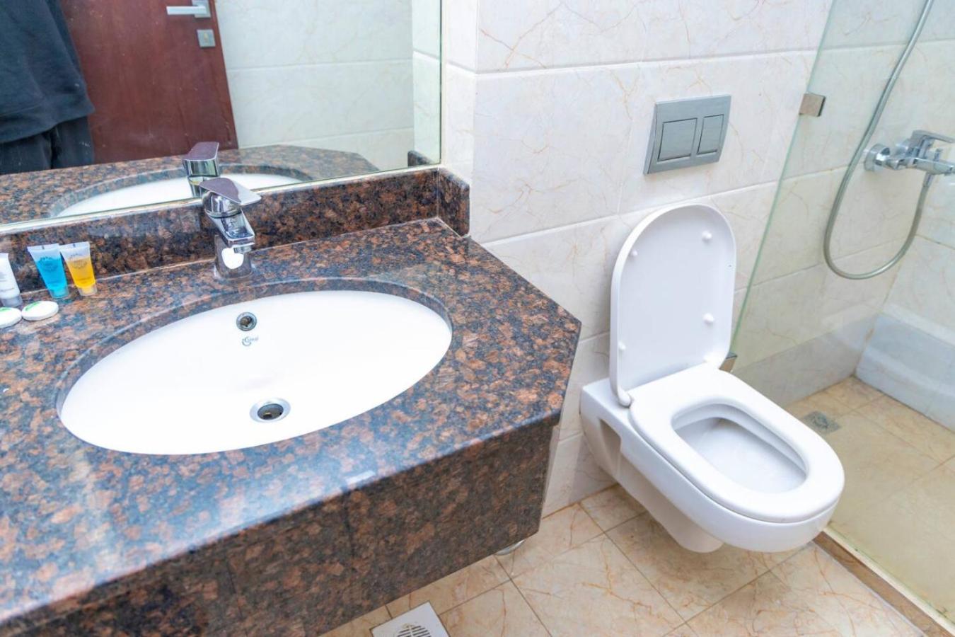 a bathroom with a sink and a toilet at Aspire Tower - Unique One Bedroom in Juffair in Manama