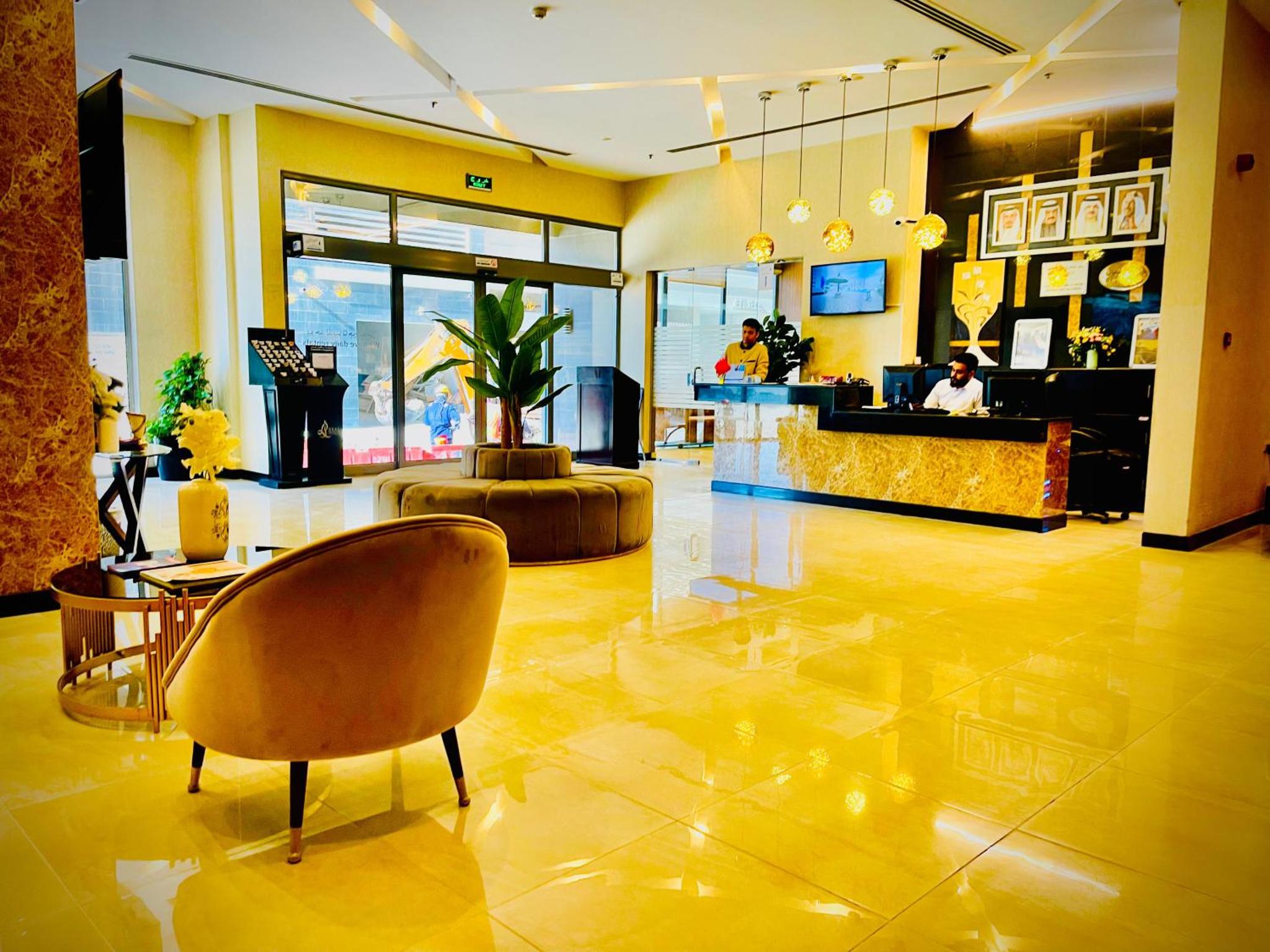 a lobby of a hotel with a chair and a table at HAVEN TOWER in Juffair
