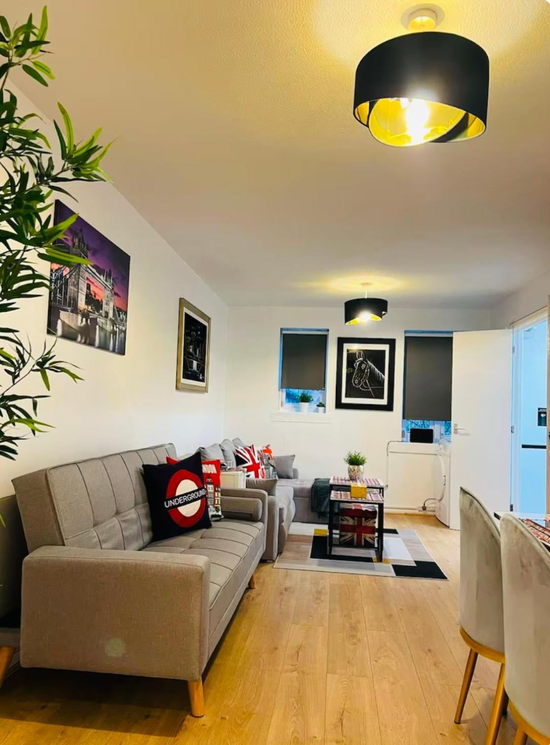 a living room with a couch and a table at Thematic London Apartment in Holloway in London