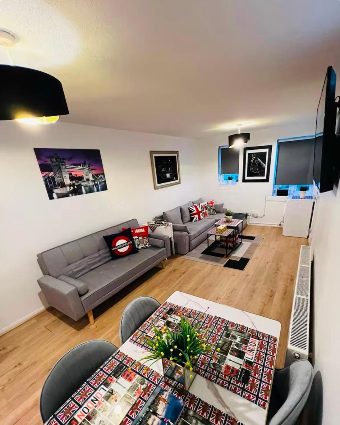 a living room with a couch and a table at Thematic London Apartment in Holloway in London +32 photos