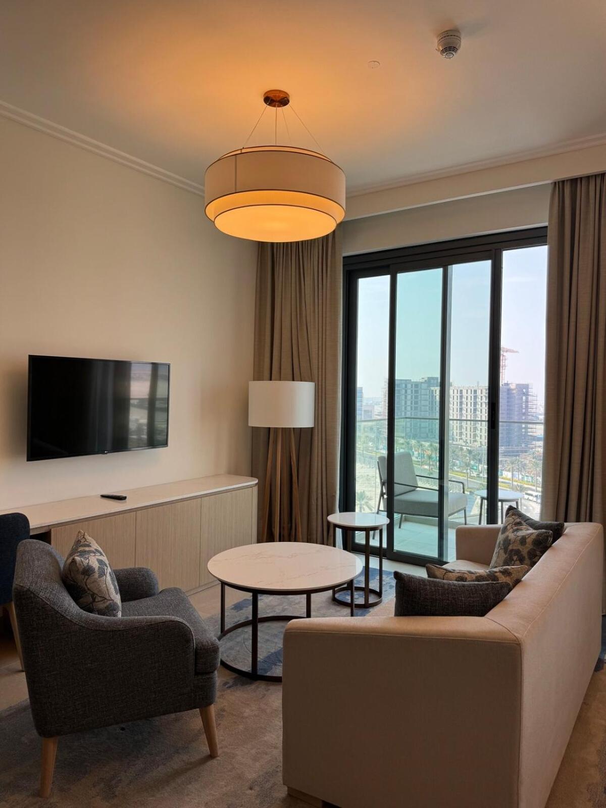 a living room with a couch and a table at Address Residence Marassi Vista-studio in Amwaj Island