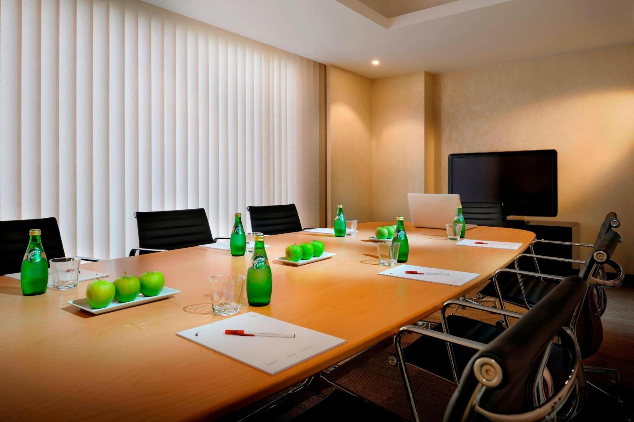 a conference room with a long table with green bottles at Residence Inn by Marriott Manama Juffair in Manama +20 photos