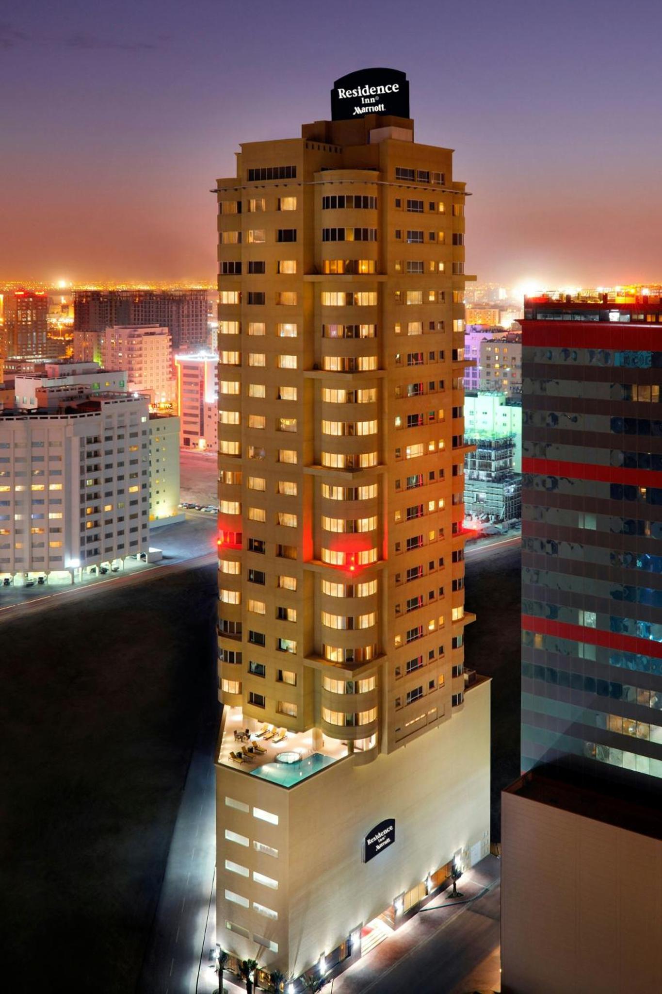 a view of a tall building at night at Residence Inn by Marriott Manama Juffair in Manama