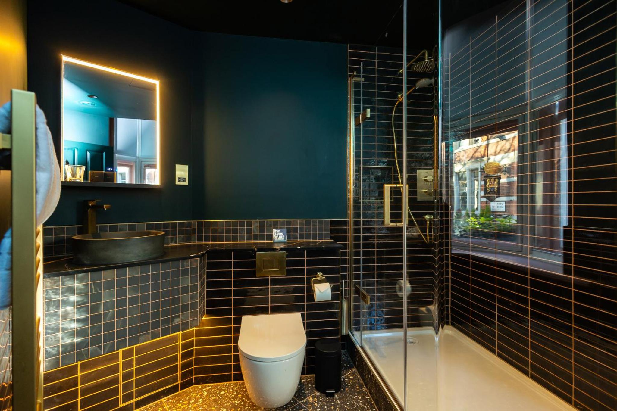 a bathroom with a toilet and a sink and a shower at The Spice of Life in London +15 photos