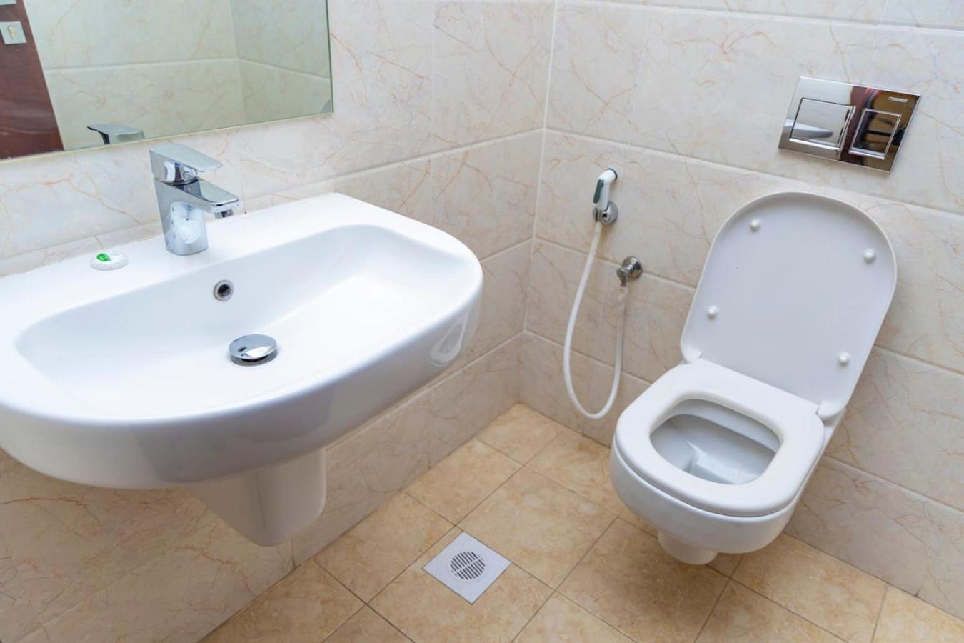 a bathroom with a sink and a toilet at Aspire Tower - One Bedroom Spacious Apartment in Manama