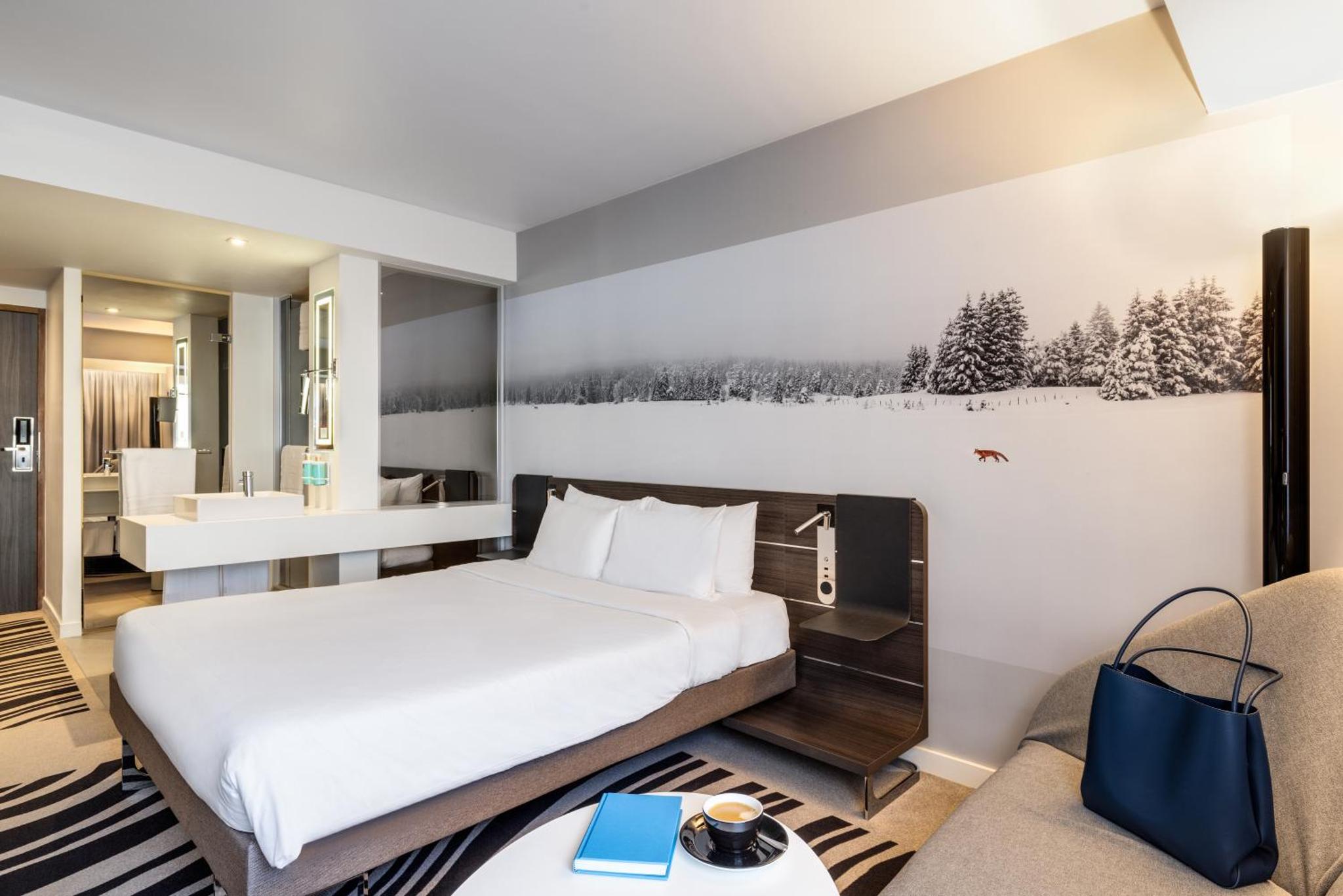 a hotel room with a bed and a bathroom at Novotel London Tower Bridge in London +133 photos