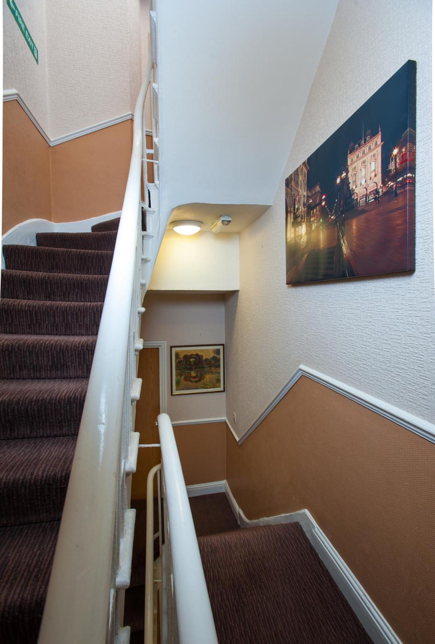 a staircase in a building with a painting on the wall at Dover Hotel - B&B in London +38 photos
