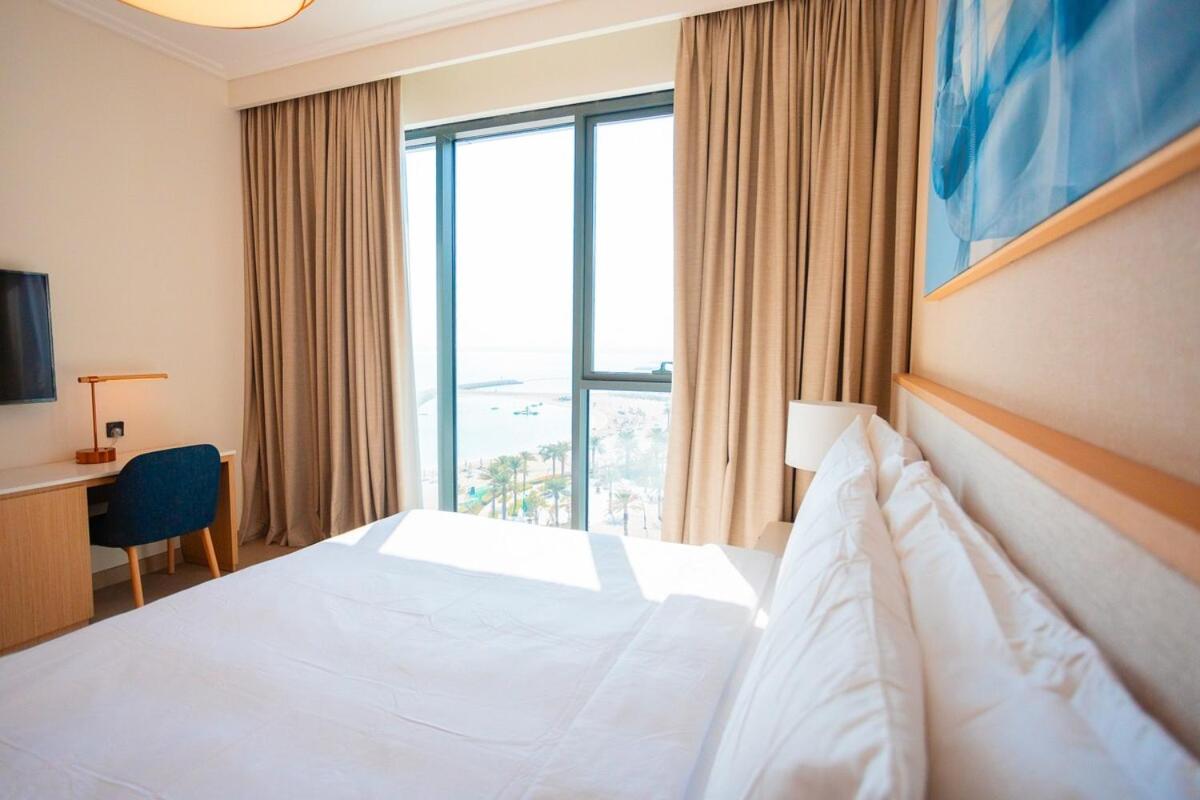 a hotel room with a bed and a large window at Spacious 2BDR Address Vista PrivateTerrace in Amwaj Island +48 photos