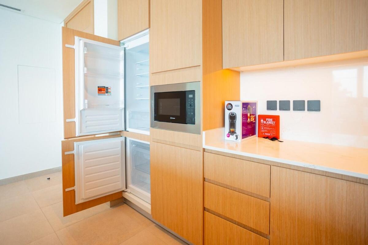 a kitchen with an open refrigerator with a microwave at Spacious 2BDR Address Vista PrivateTerrace in Amwaj Island