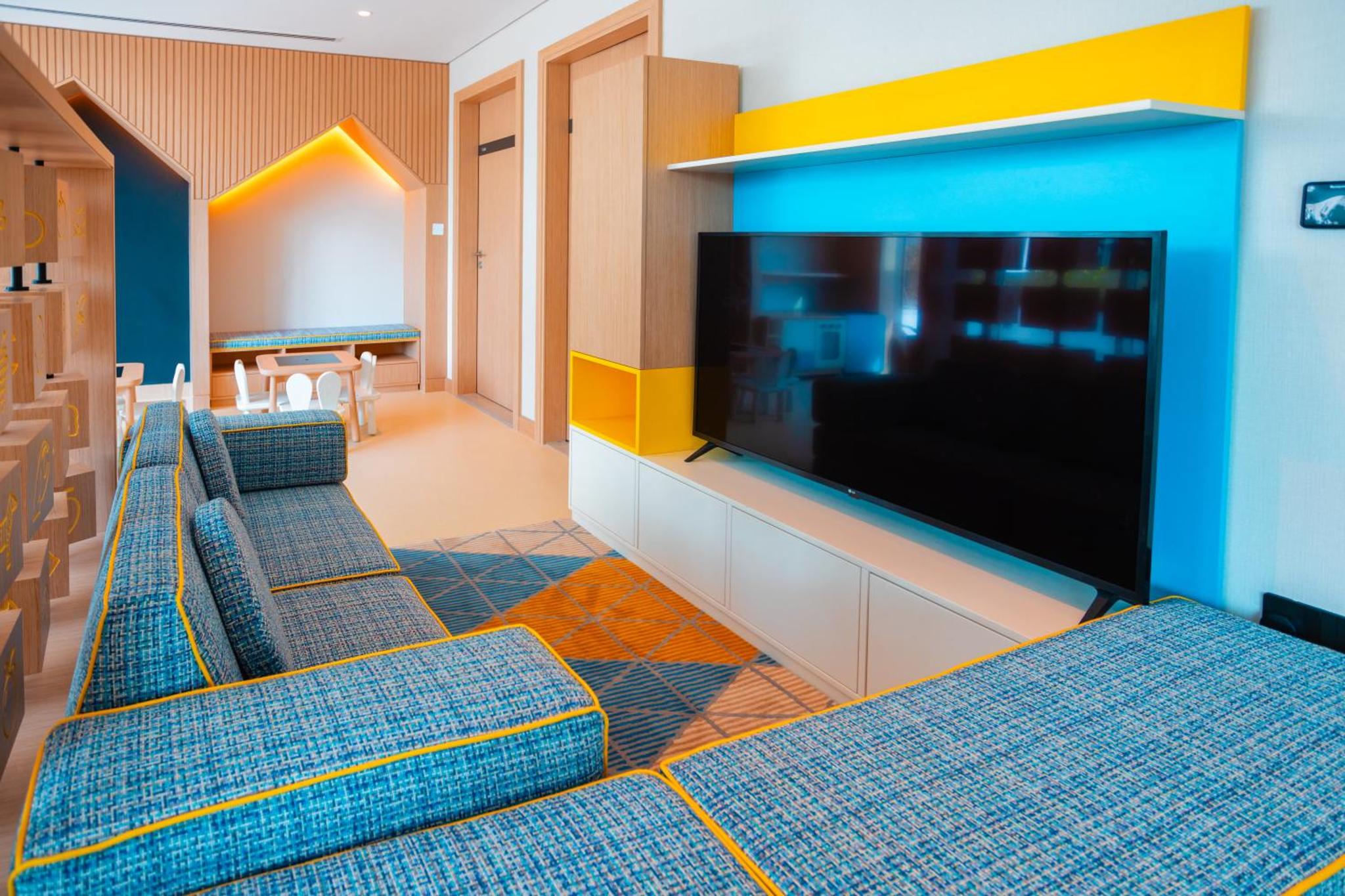 a living room with chairs and a flat screen tv at Spacious 2BDR Address Vista PrivateTerrace in Amwaj Island