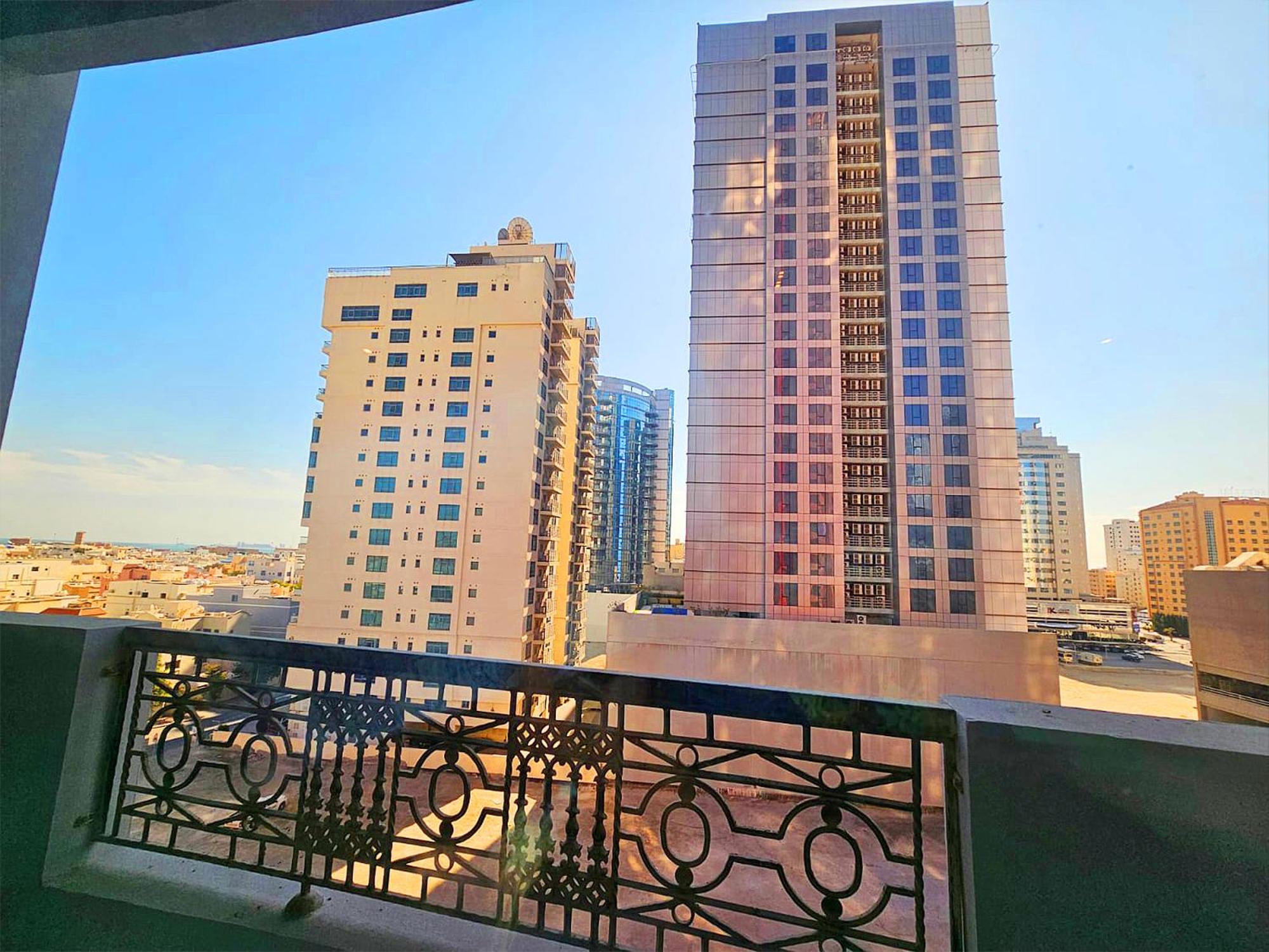 a balcony with a view of some tall buildings at Al Faris Suites 2 in Juffair
