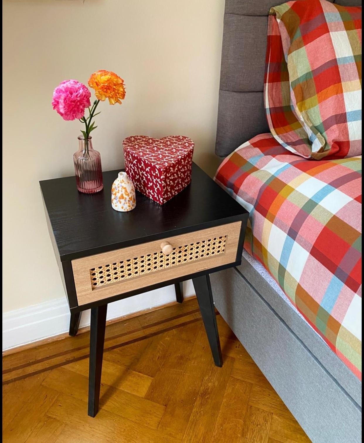 a table with flowers on it next to a bed at Prime Location Wembley Stadium London in London +3 photos