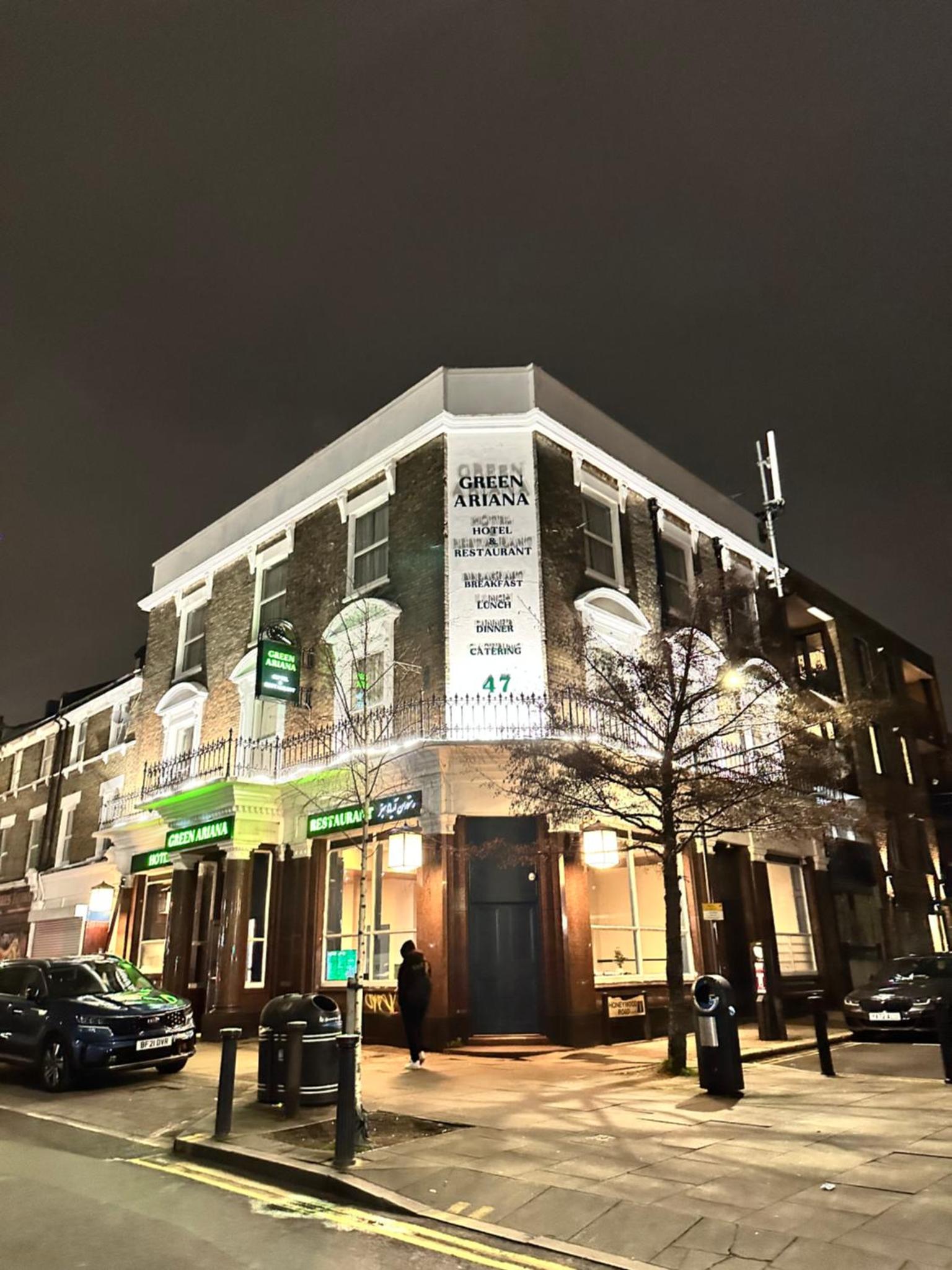 a building with a sign on the side of it at Green Ariana Hotel - near Wembley and central London in London