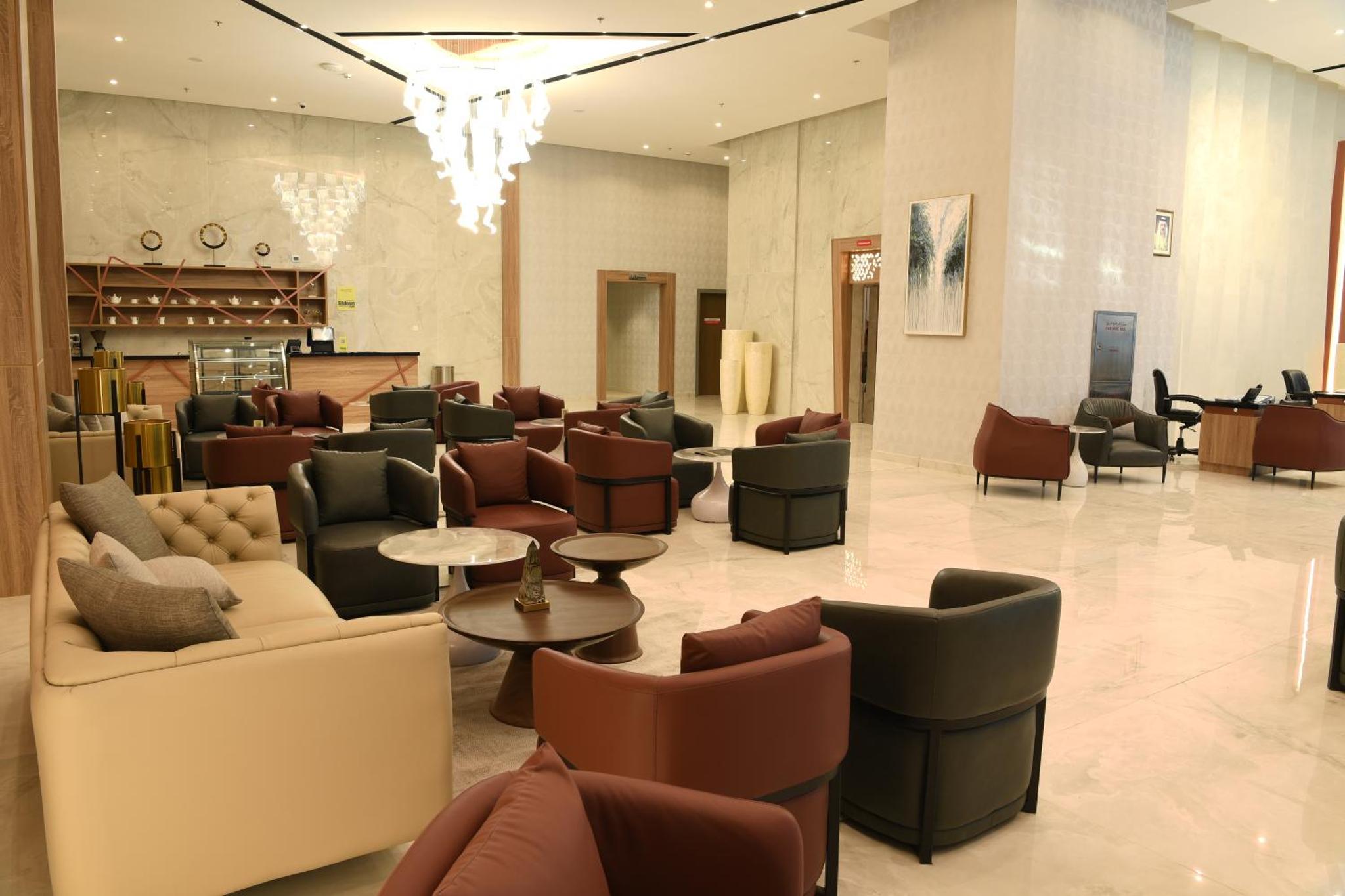 a lobby with couches and chairs in a store at The Mark Hotel in Manama