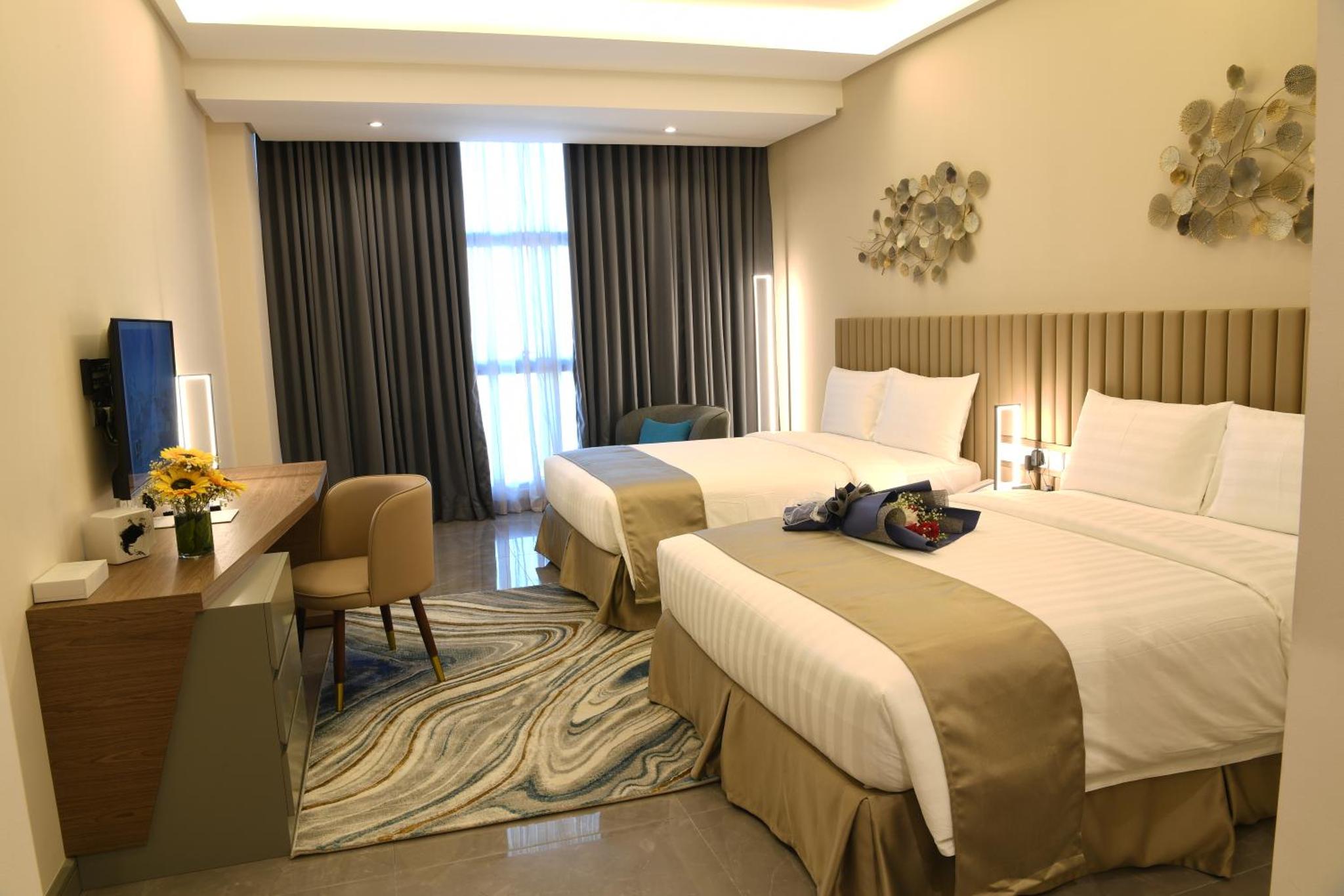 a hotel room with two beds and a desk at The Mark Hotel in Manama +27 photos